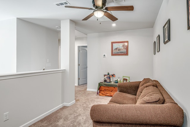 carpeted living room with ceiling fan