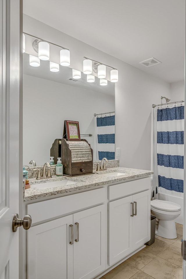 bathroom with tile patterned flooring, vanity, and toilet