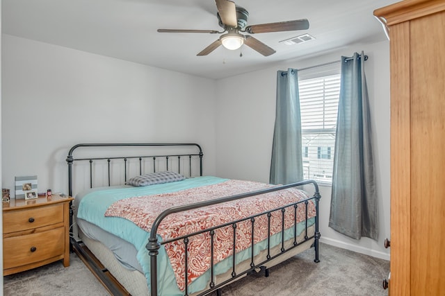 bedroom with multiple windows, ceiling fan, and carpet