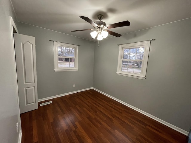 unfurnished room with ceiling fan and dark hardwood / wood-style floors