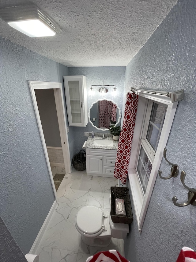 bathroom with vanity and a textured ceiling