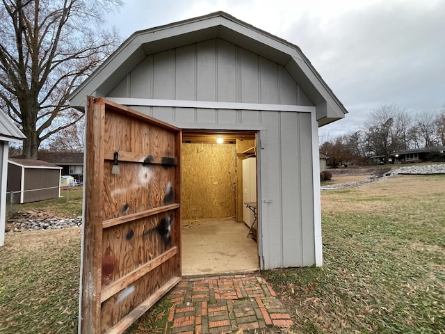 view of outdoor structure featuring a lawn