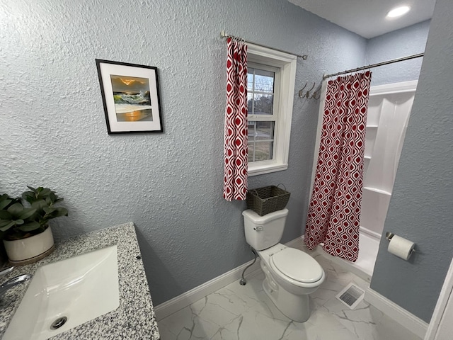 bathroom with vanity, toilet, and walk in shower