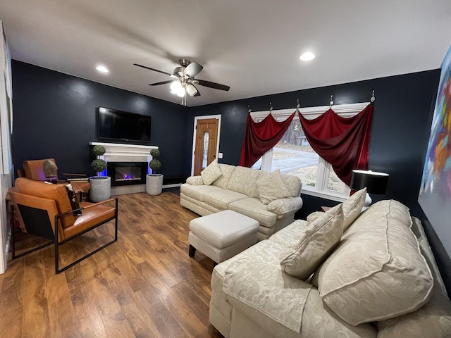 living room featuring ceiling fan and wood-type flooring