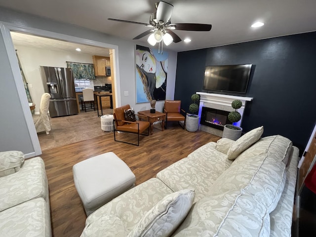 living room featuring ceiling fan and wood-type flooring