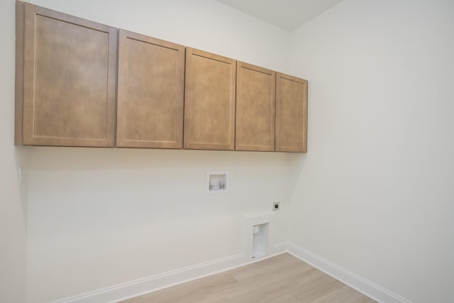 laundry area featuring washer hookup, electric dryer hookup, cabinets, and light wood-type flooring