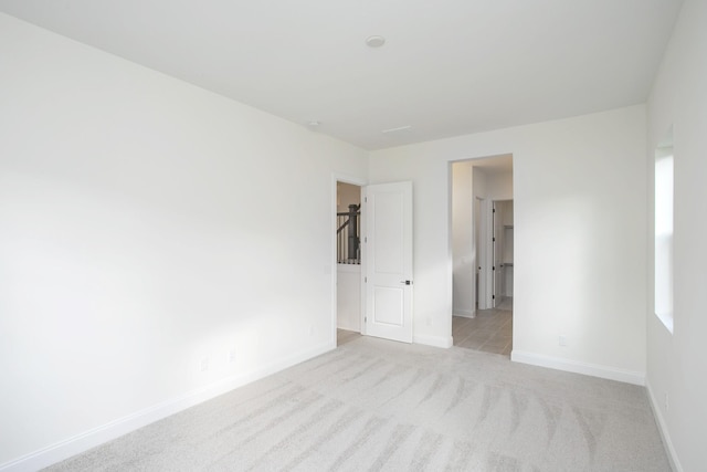 unfurnished room featuring light colored carpet