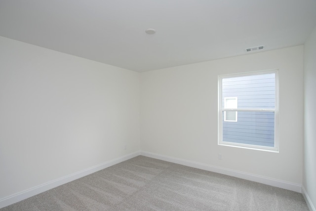 spare room with light colored carpet