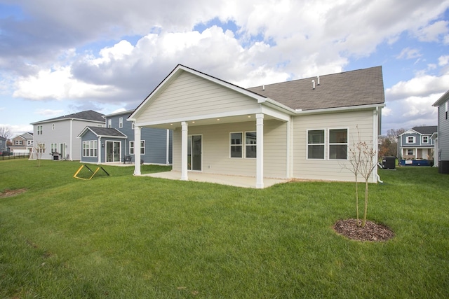 rear view of property with a yard, a patio, and central AC unit