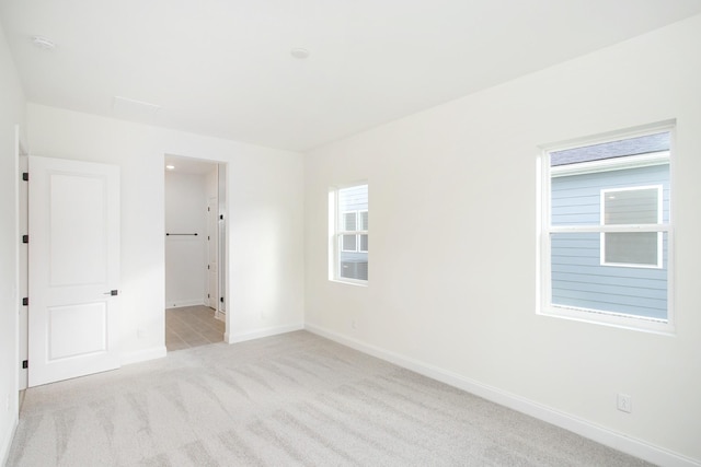 unfurnished room with light carpet