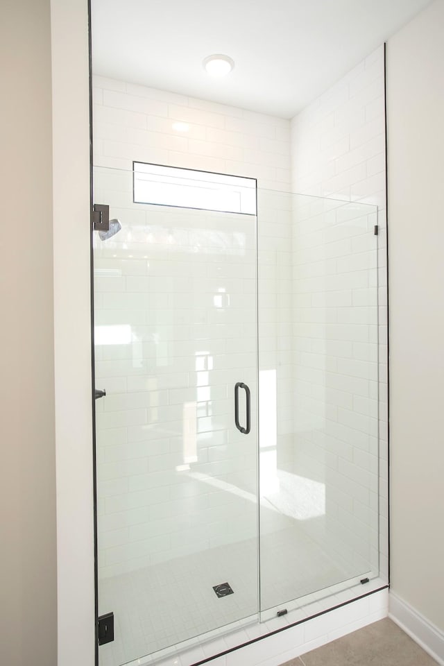 bathroom with a shower with shower door