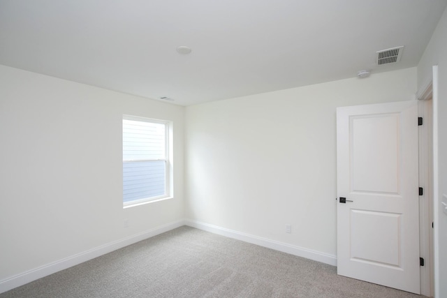 unfurnished room with light carpet