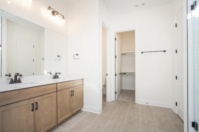 bathroom featuring tile patterned flooring, vanity, and toilet