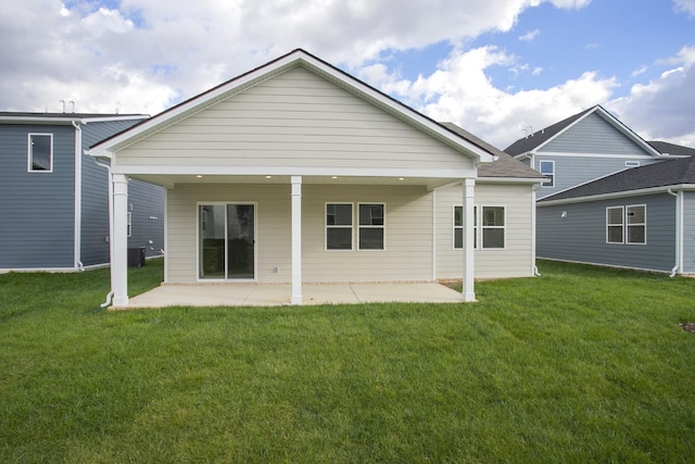 back of property featuring a patio area and a yard