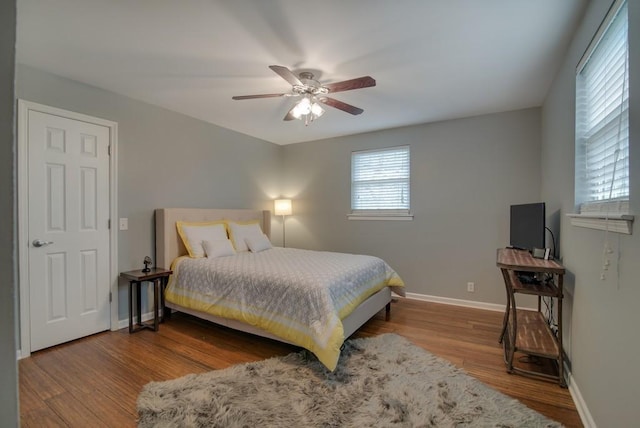 bedroom with hardwood / wood-style flooring and ceiling fan