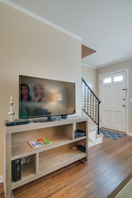 foyer entrance featuring hardwood / wood-style flooring and ornamental molding