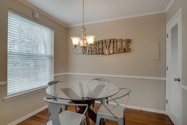 dining area with a chandelier, dark hardwood / wood-style floors, and ornamental molding