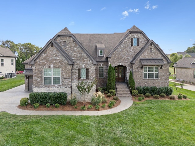 view of front of house with french doors, a front lawn, and central air condition unit