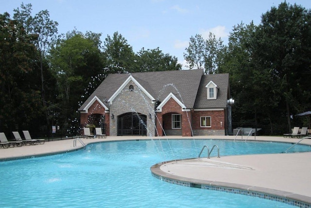 view of pool featuring pool water feature and a patio area