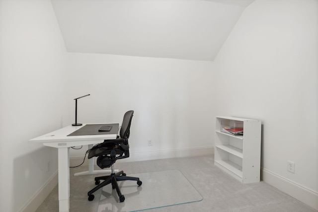 office area with light carpet and vaulted ceiling