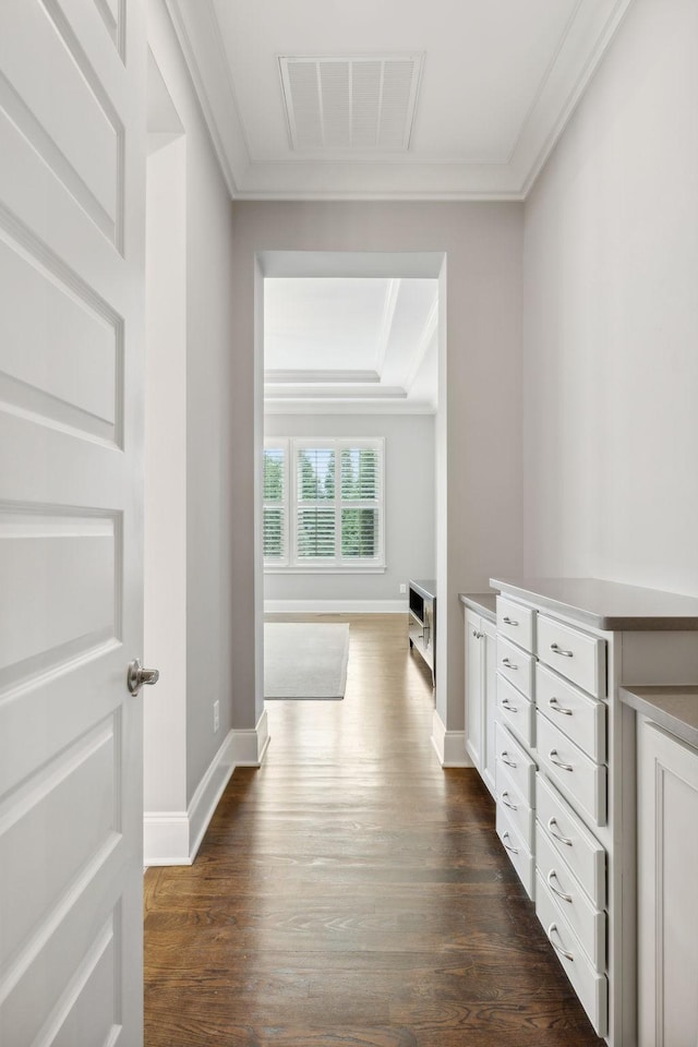 hall with dark hardwood / wood-style flooring and crown molding