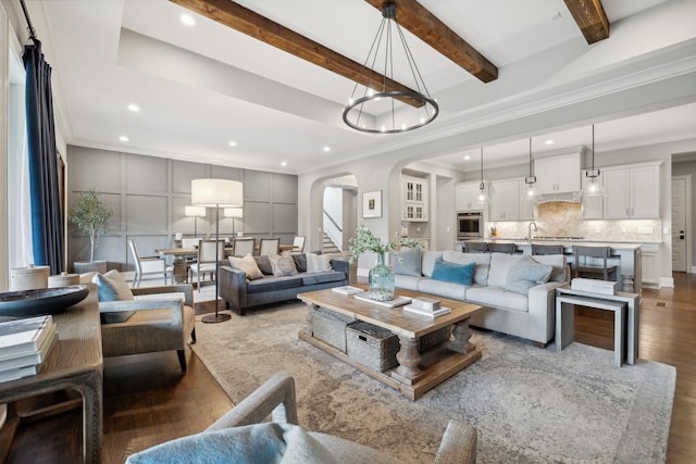 living room with crown molding, hardwood / wood-style floors, and beamed ceiling