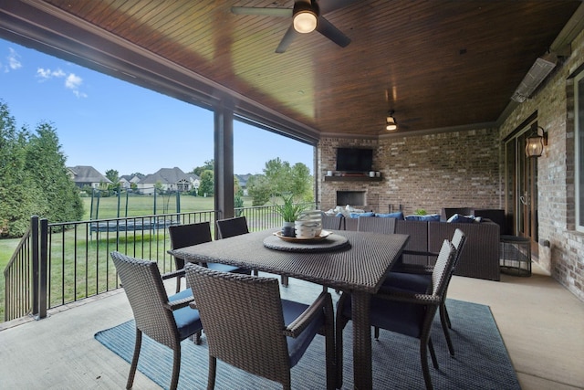 view of patio featuring ceiling fan and an outdoor brick fireplace