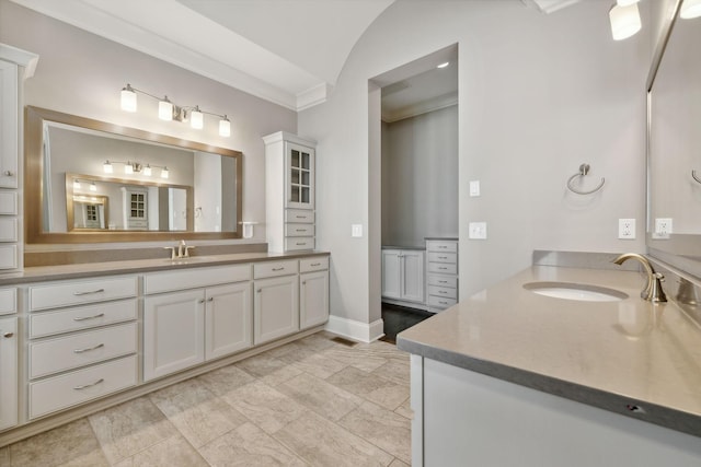 bathroom featuring lofted ceiling, vanity, and crown molding