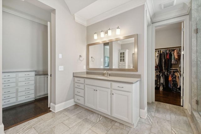 bathroom with vanity, an enclosed shower, and ornamental molding