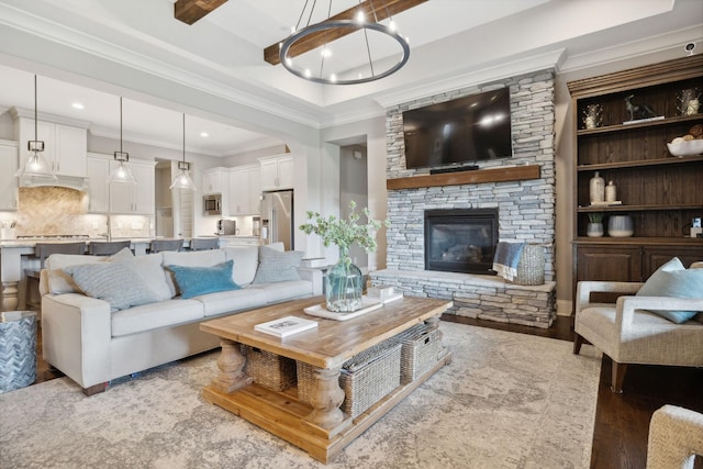 living room with a fireplace, ornamental molding, and light wood-type flooring