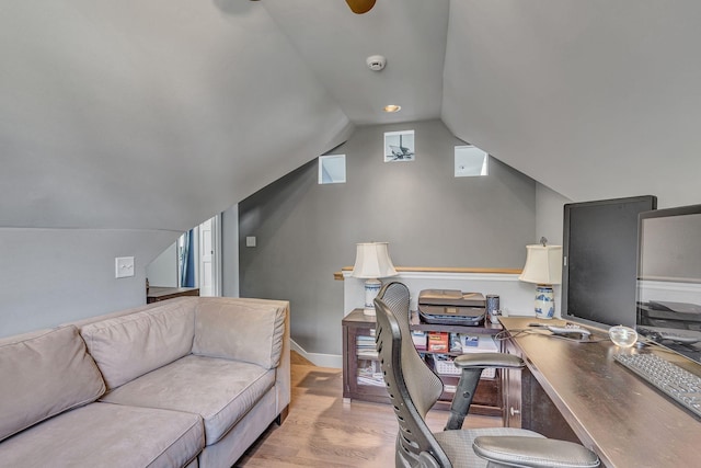 office featuring light hardwood / wood-style floors and lofted ceiling