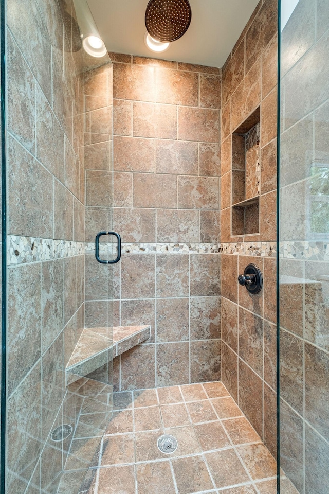 bathroom featuring a shower with door