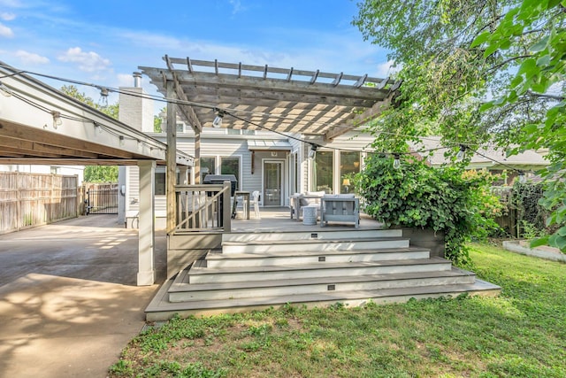 wooden deck with a pergola and a lawn