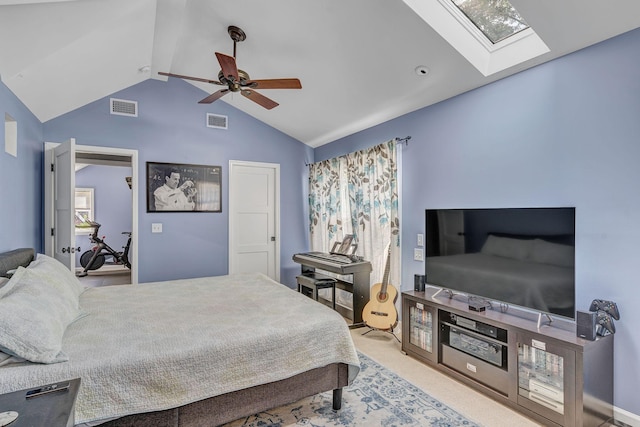 bedroom featuring ceiling fan, lofted ceiling with skylight, and light carpet