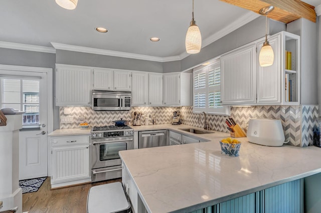 kitchen with kitchen peninsula, white cabinetry, pendant lighting, and appliances with stainless steel finishes