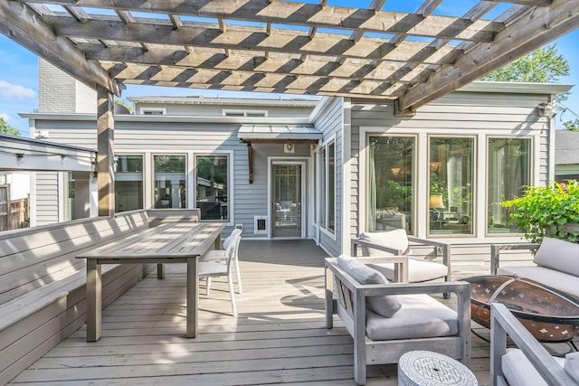 deck with a pergola and a fire pit