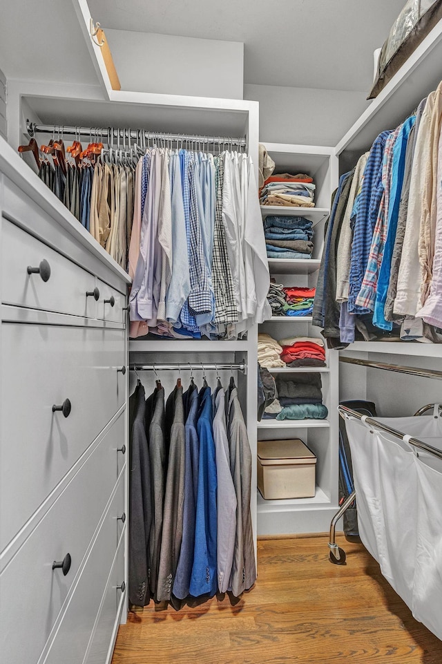 walk in closet with hardwood / wood-style flooring