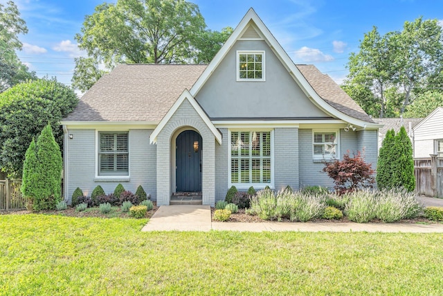 tudor-style house with a front lawn