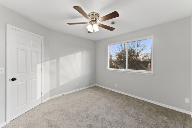 empty room with carpet and ceiling fan