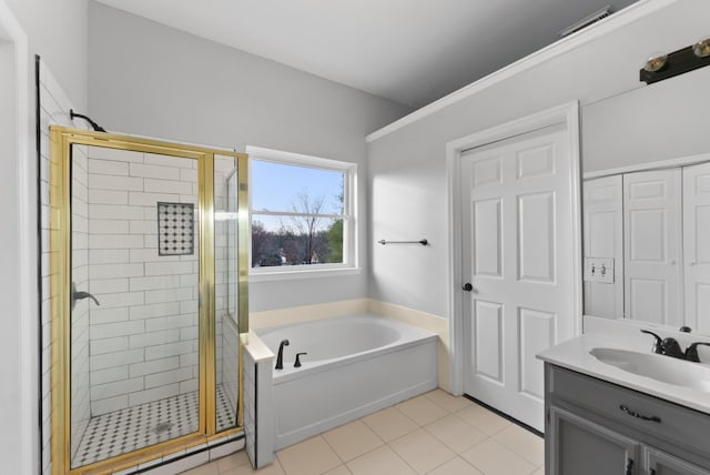 bathroom with plus walk in shower, tile patterned flooring, and vanity