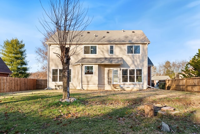 back of property featuring a lawn