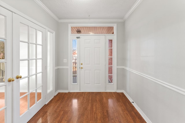 entryway featuring hardwood / wood-style flooring, a textured ceiling, crown molding, and french doors