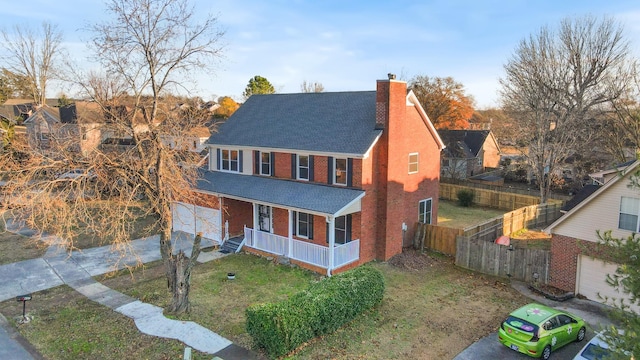 view of front of home with covered porch and a front lawn