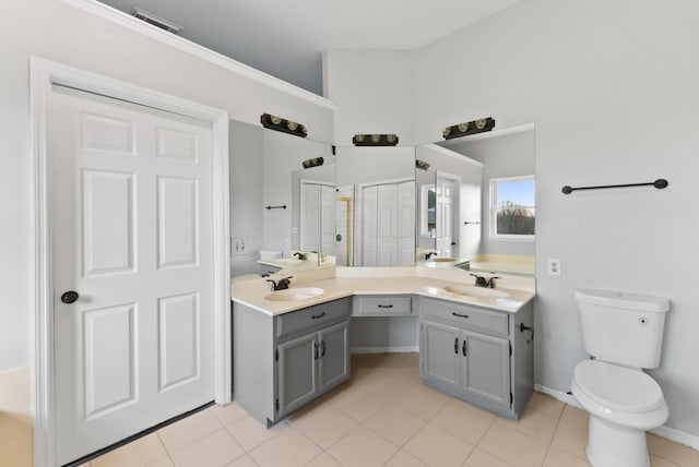 bathroom featuring tile patterned floors, vanity, and toilet