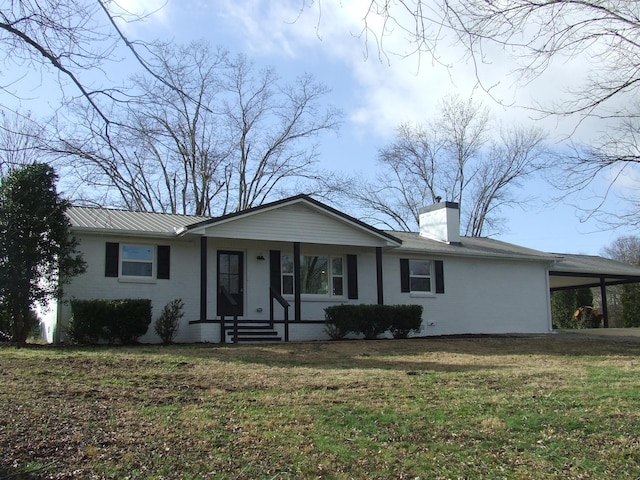 single story home featuring a front lawn and a carport