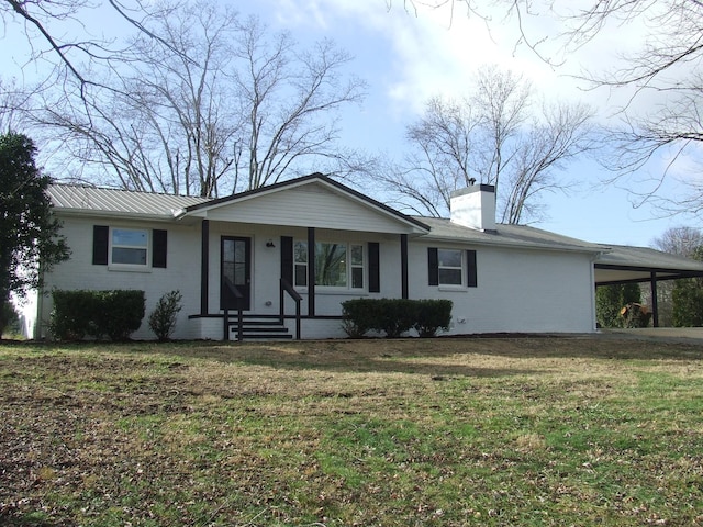 ranch-style home featuring a front yard and a carport