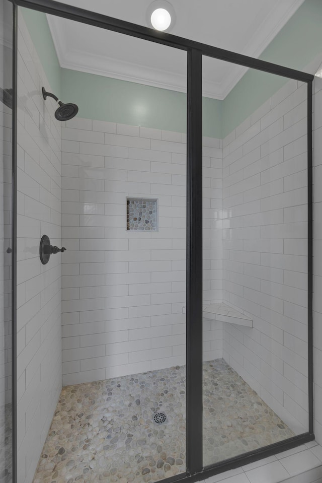 bathroom featuring tiled shower and ornamental molding