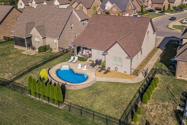 view of swimming pool featuring a yard and a patio