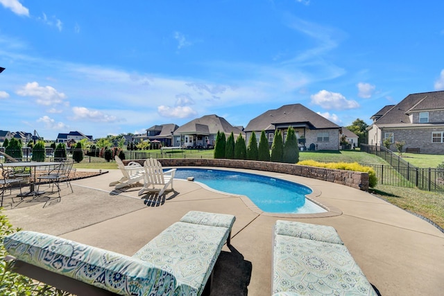 view of pool featuring a lawn and a patio area