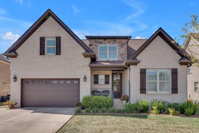 view of front of property with a front yard and a garage